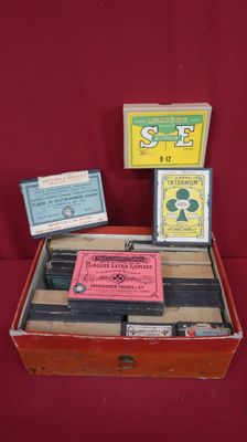 a wooden box filled with different items on a red surface