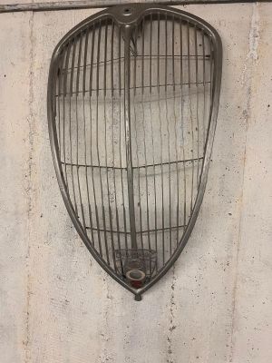 a metal grill hanging on the side of a wall