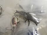 several fishing lures in a plastic bag on a table