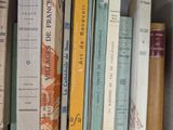 many books that are on a shelf in a book case