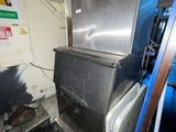 an image of a refrigerator and freezer inside of a building