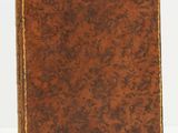 un vieux livre en cuir marron aux tranches dorées