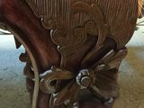 a close up of a wooden table with carvings on it