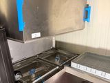 a kitchen with stainless steel appliances and blue tape on the wall