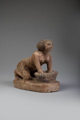 an image of a statue of a monkey sitting on a rock