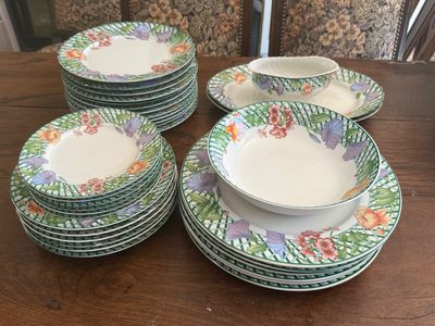 a lot of plates and bowls on the table