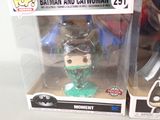 batman and catwoman figurines in boxes on a table