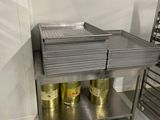 a stainless steel table with two cans of beer on it