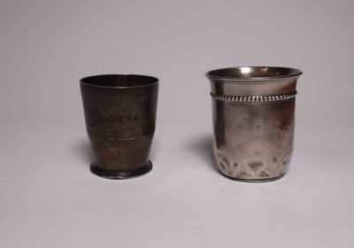 two silver cups sitting next to each other on a table