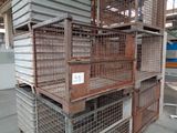 many cages stacked on top of each other in a warehouse