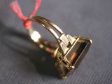 a gold ring with a black stone on it