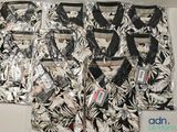 four men ' s black and white hawaiian shirts are lined up on a table