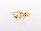 a close up of a gold ring with three sapphire stones
