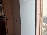 a white refrigerator sitting in the corner of a room