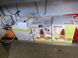 several boxes of food are stacked on a metal shelf in a kitchen