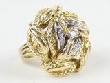 a close up of a gold and diamond ring on a white background