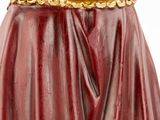 the statue of a woman in a red cloak with a gold crown on her head