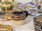 many different types of pottery sitting on a table