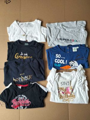 many t - shirts laid out on a cardboard box