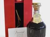 a bottle of liquor sitting next to a red box