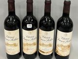 three bottles of red wine are lined up on a table