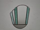 a picture of a round mirror with a green stripe around it