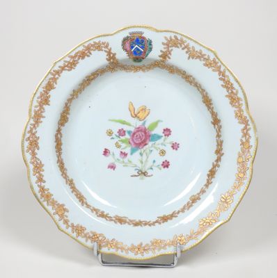 a white plate with gold trim and flowers on it