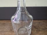 a clear glass vase sitting on a wooden table