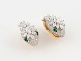 a pair of emerald and diamond earrings