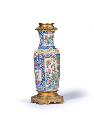 a vase that is sitting on a stand on a white surface