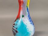 a glass vase with a colorful design on it