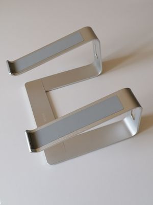 three metal hooks on a white surface