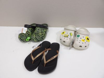 three pairs of sandals and a pair of slippers on a table