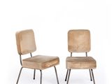 pair of chairs with upholstered backrests and metal legs