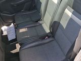 four seats in the back of a car that are empty
