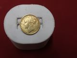 an image of a gold coin sitting on top of a white box