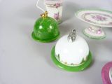 three small dishes and a cup on a table