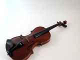a violin that is sitting on a white surface