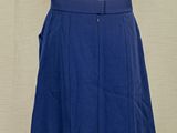 a white mannequin with a blue skirt and a white shirt