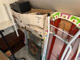 a stack of boxes on top of a rack in the corner of a room