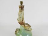 a small green vase with a bird on it