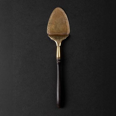a close up of a spatula on a black surface