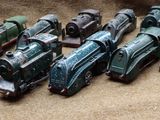 a lot of toy trains that are sitting on a table