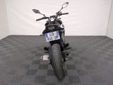a motorcycle that is parked in a room with a checkered floor
