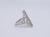 a close up of a diamond ring on a white surface