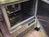 a small oven that is open in a kitchen