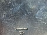 a close up of a metal pan with a handle on it