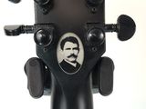 a guitar head with a picture of a man on it