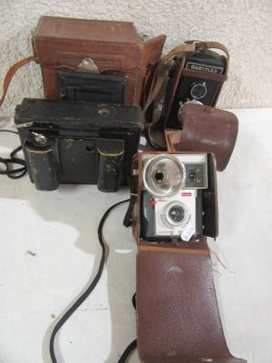 two cameras and a case sitting on a table