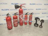 fire extinguisors are lined up on a table in front of a wall